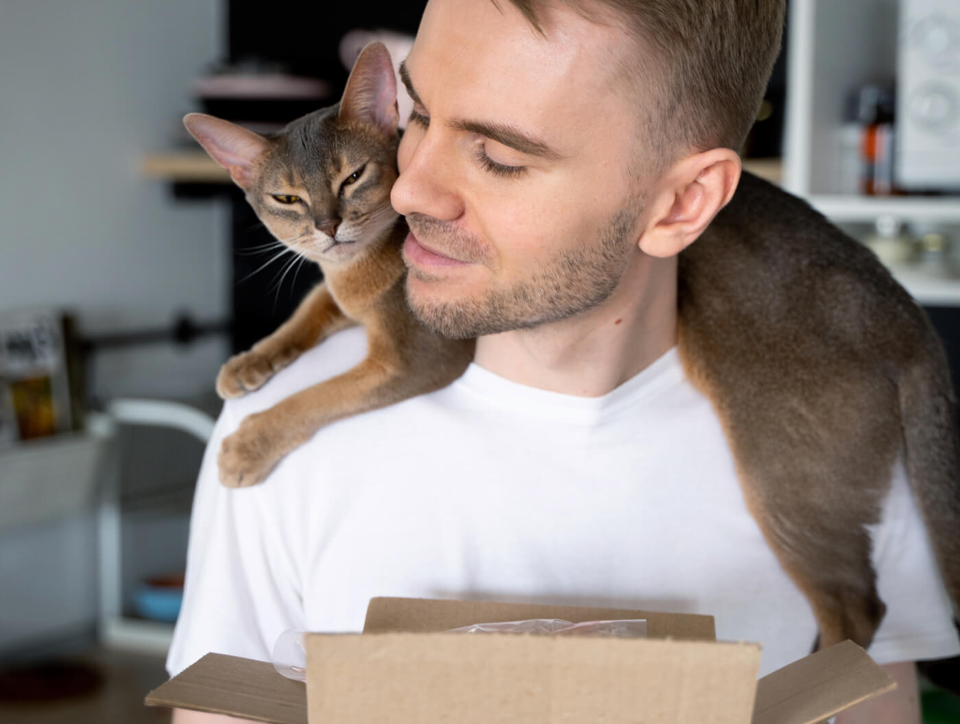Man receives Autoship package with cat on his shoulders